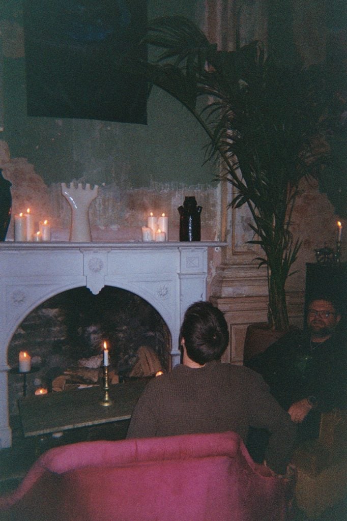 photo of two men by a fireplace