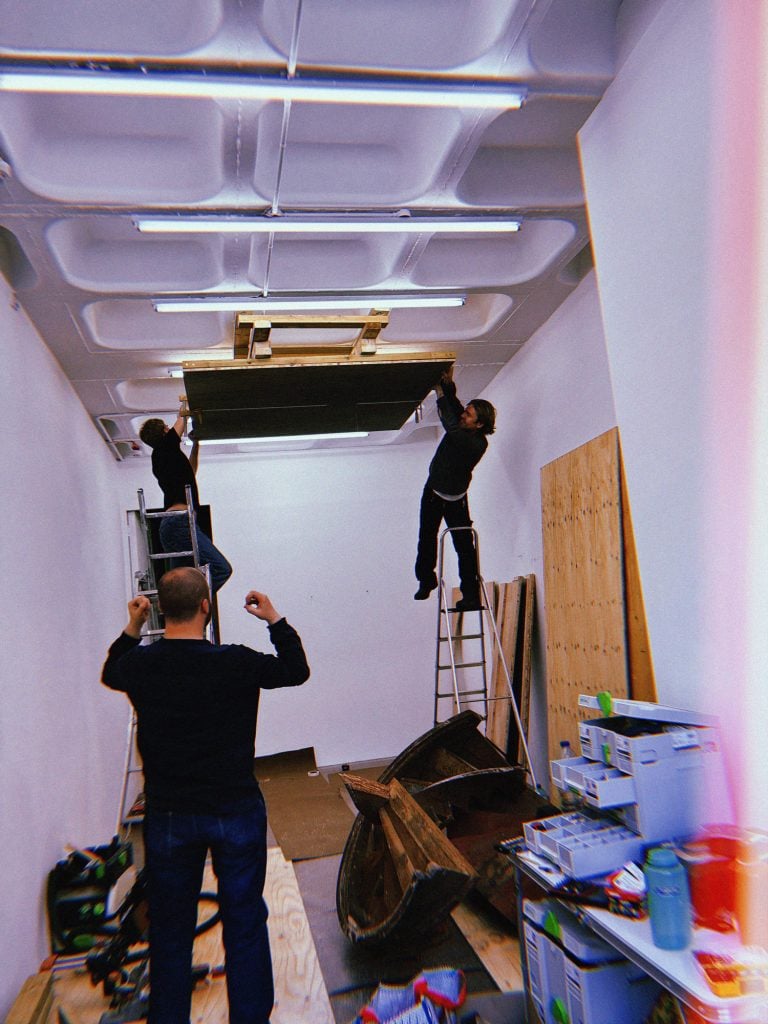 photo of 3 people installing a panel over light fixtures