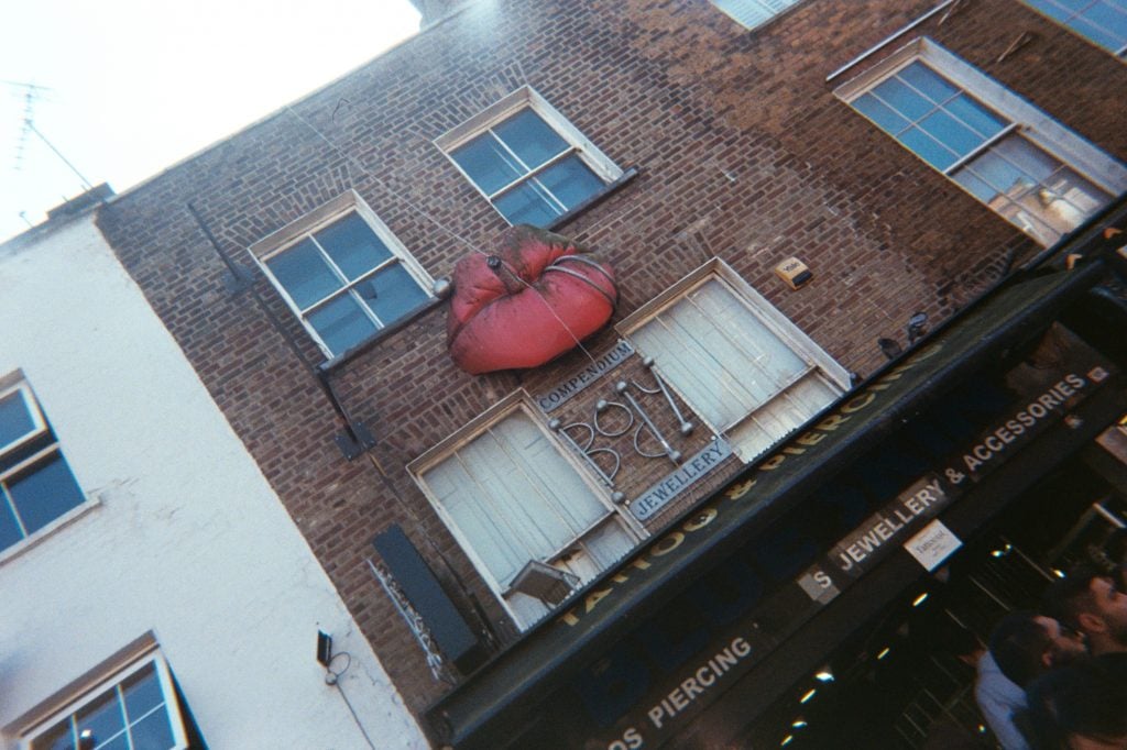photo of the exterior of a building and a lip with cigarette sculpture attached to it