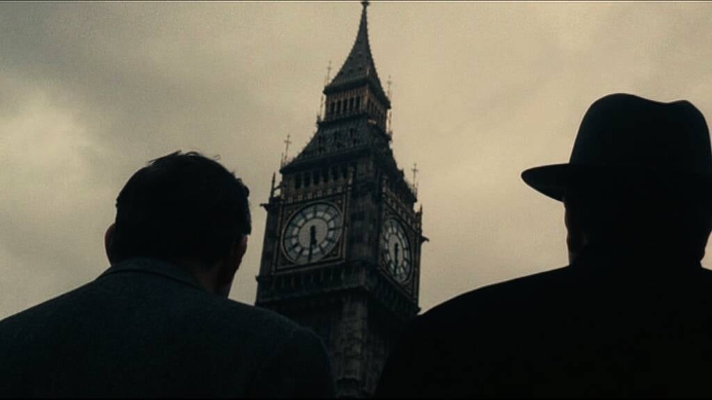 A still from Christian Marclay's "The Clock" featuring two men looking up at the Big Ben clocktower in London. 