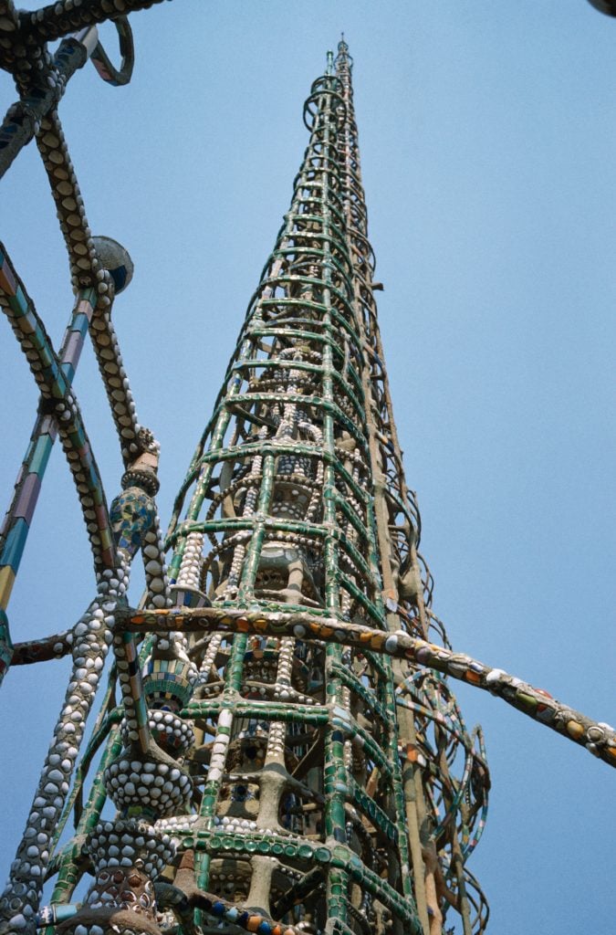 one of the watts towers, a metal structure encrusted with seashells, glass, and ceramics