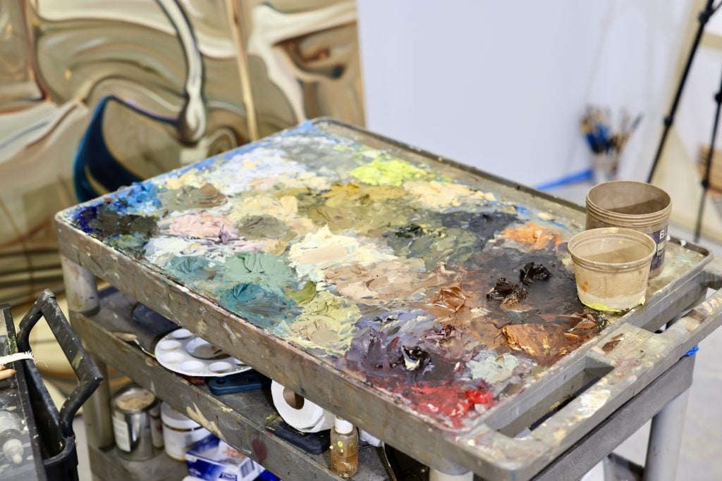 a rolling artist palette with pigment paint on top