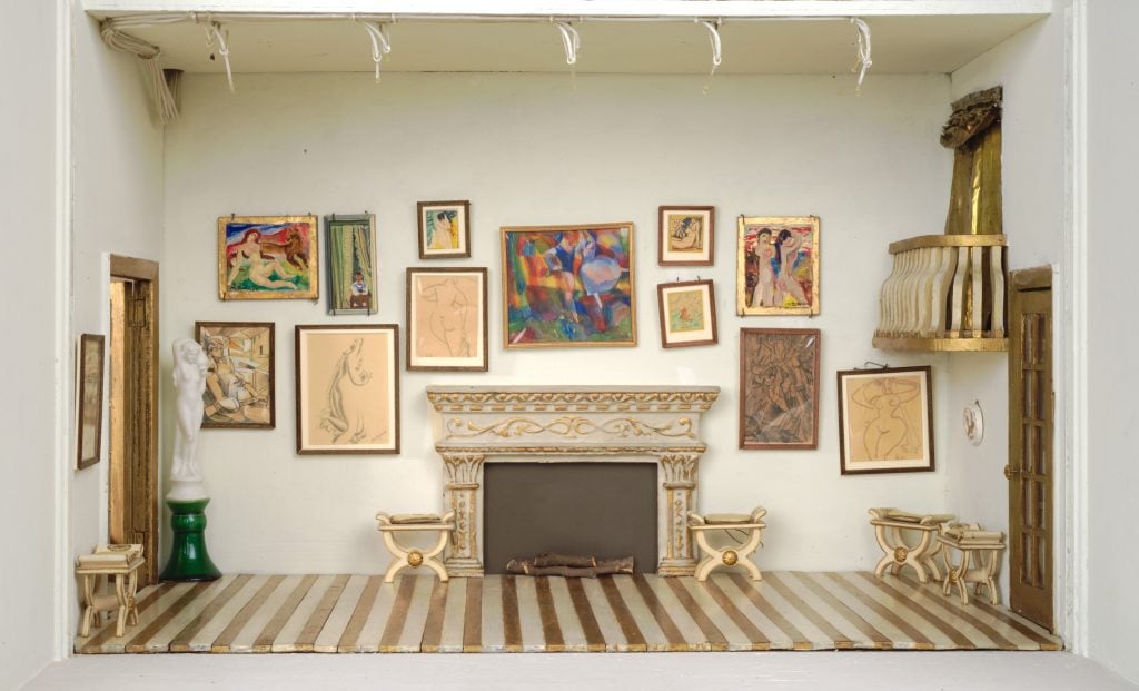 Dollhouse art gallery room with miniature paintings and sculptures displayed