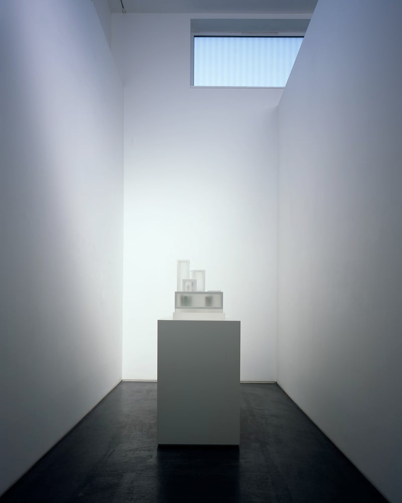 an image of an artwork on a white plinth against white walls