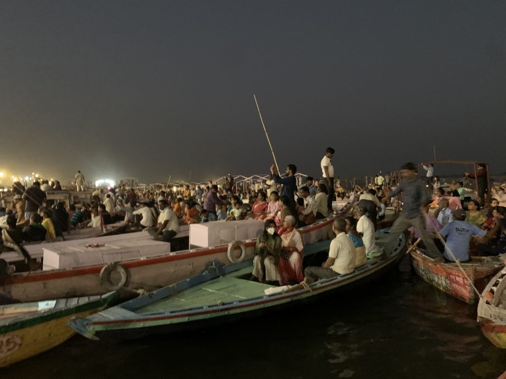 The Ganga River in Varanasi, India, seen at night, packed with small personal watercraft. 