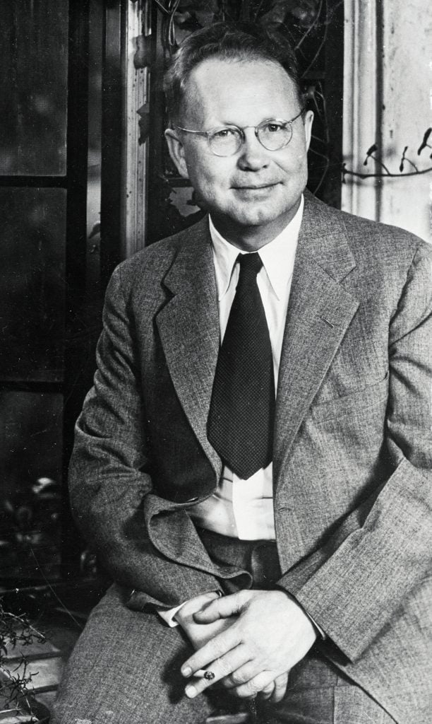 a black and white photograph of a white man wearing a suit and tie