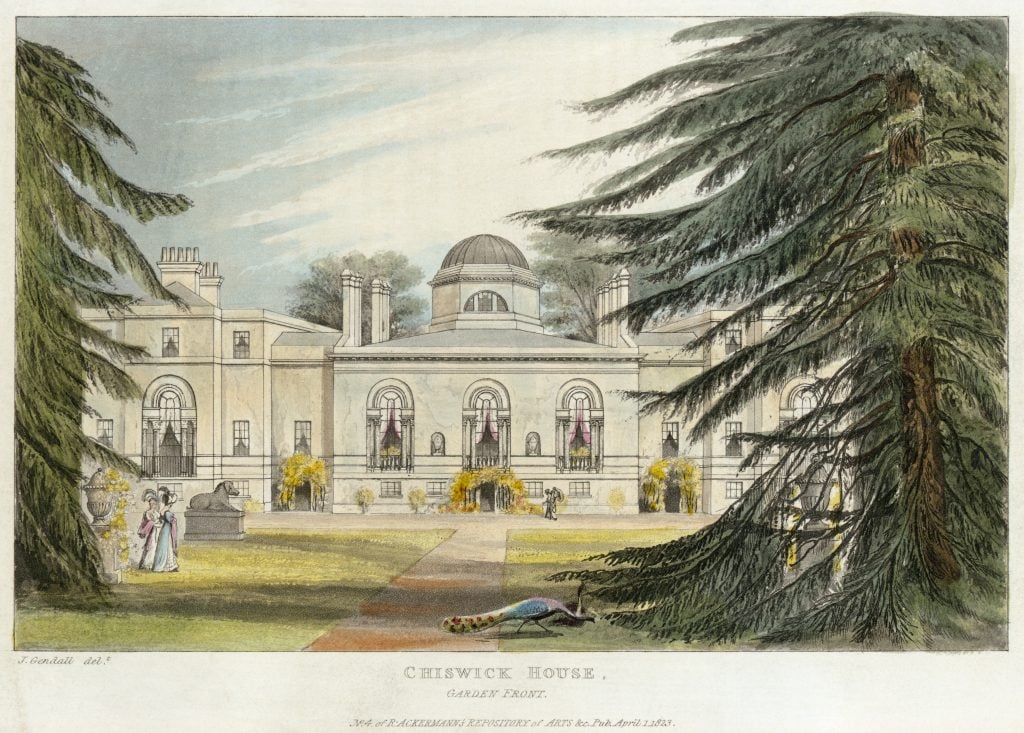 An elegant 19th-century colored engraving of Chiswick House, a neoclassical villa in London. The image shows the garden front of the house, with symmetrical windows and a large central dome. There are decorative plants and trees in the foreground, including a peacock on the lawn. Two women in period attire stroll near a statue, while other figures are visible near the building. The architecture and surrounding greenery create a serene and grand atmosphere, with vibrant colors enhancing the details of the scene.