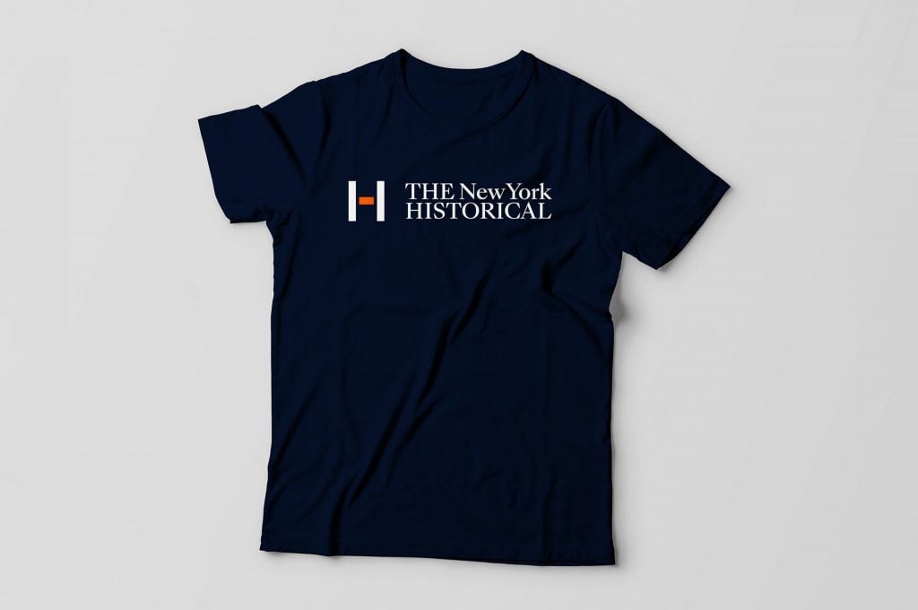 A black t-shirt with the new logo for the rebranded New York Historical. 