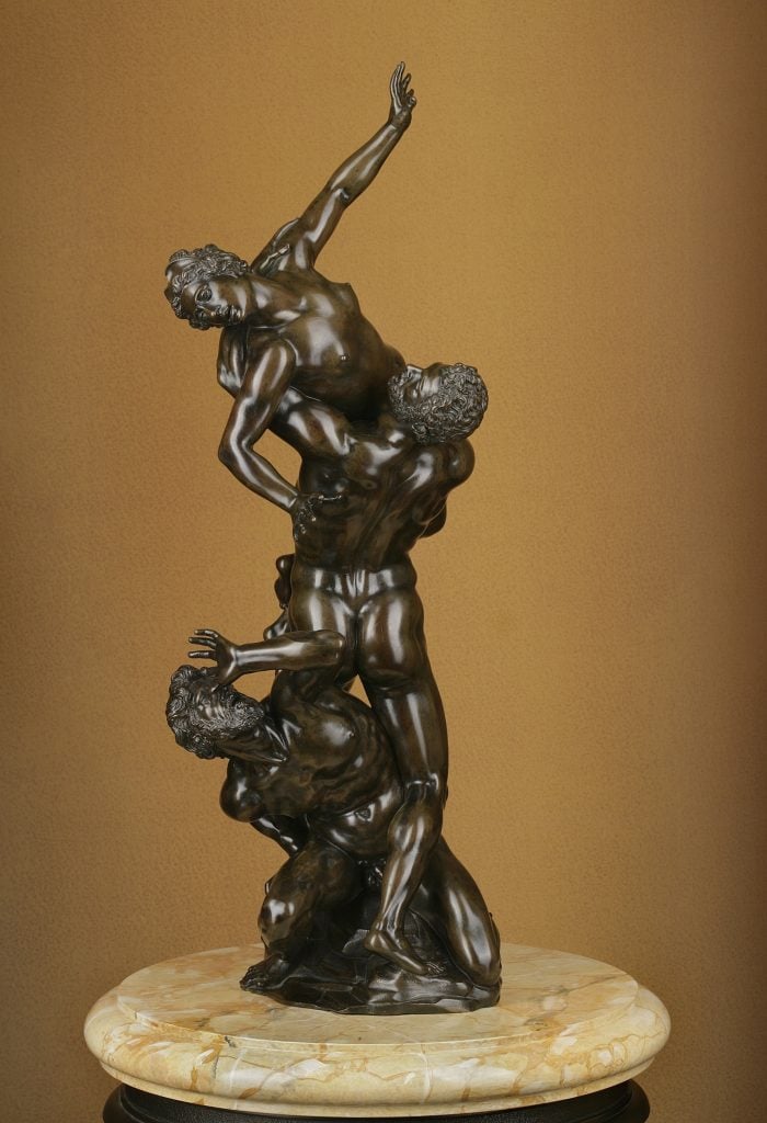 A bronze sculpture of a man abducting a woman