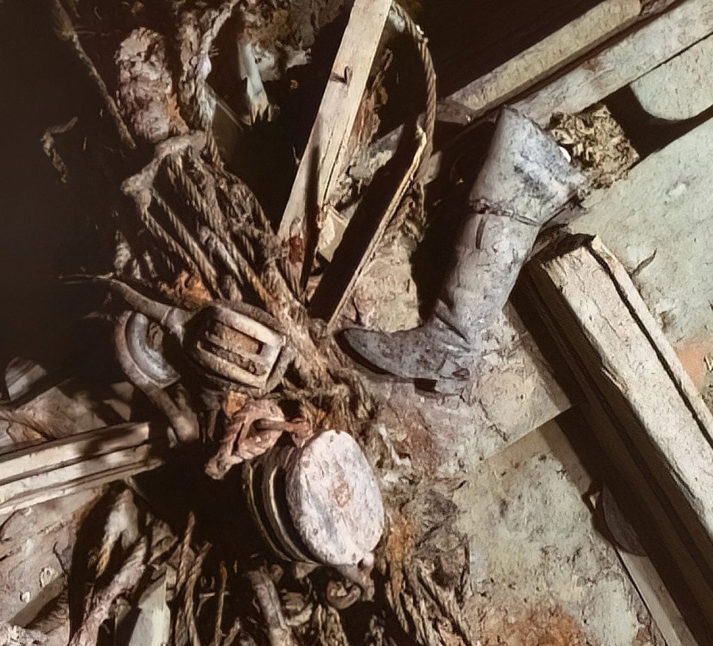 photo of a collection of items on a shipwreck at the bottom of the sea including ropes and an old boot