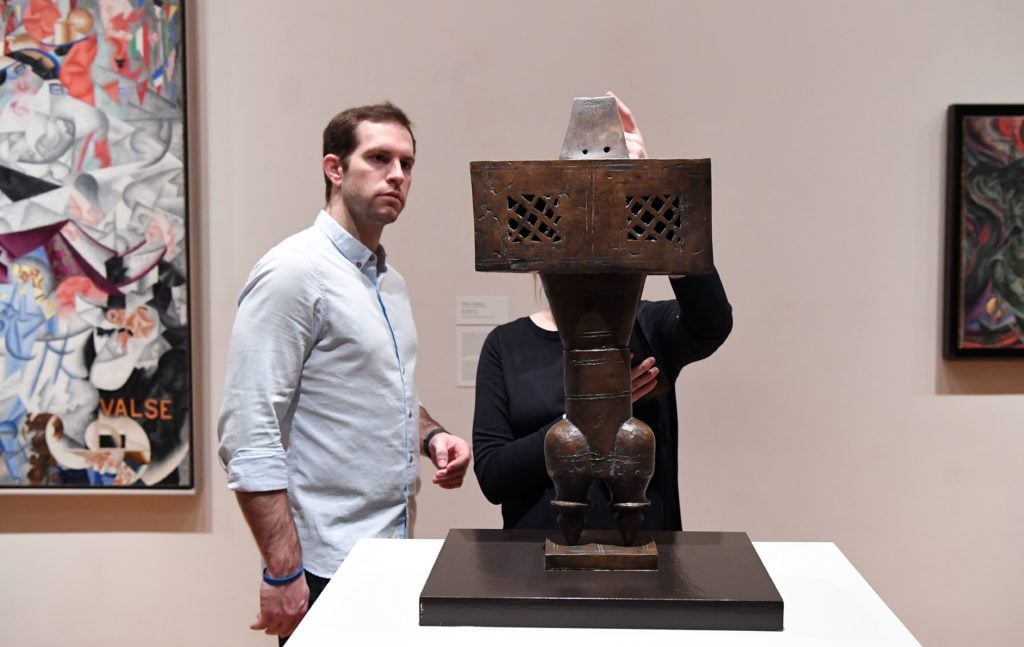 A couple looks at artwork by Parviz Tanavoli, "The Prophet, 1964" at The Museum of Modern Art on February 3, 2017 in New York City. Photo credit should read Angela Weiss/AFP/Getty Images)