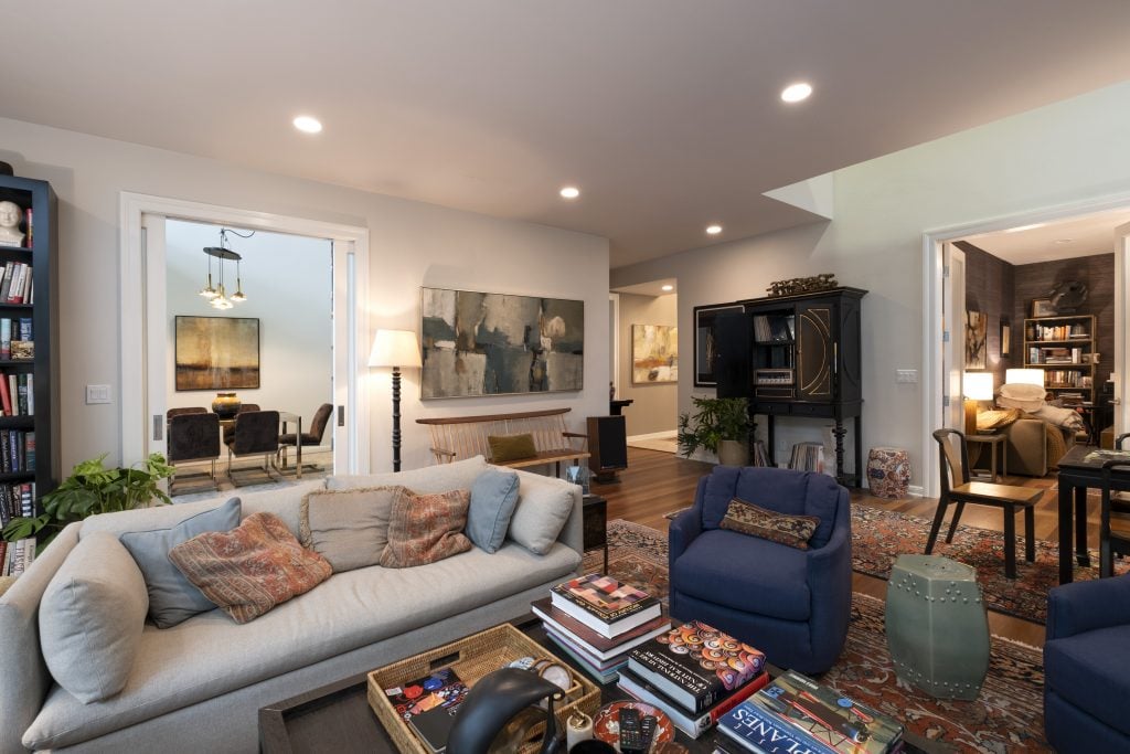 a living room with a wooden becnh visible in the background