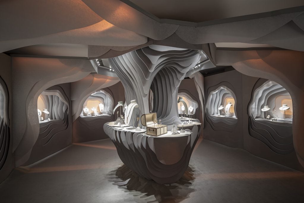 jewelry is displayed in an intricate exhibition to look like an underground chamber 