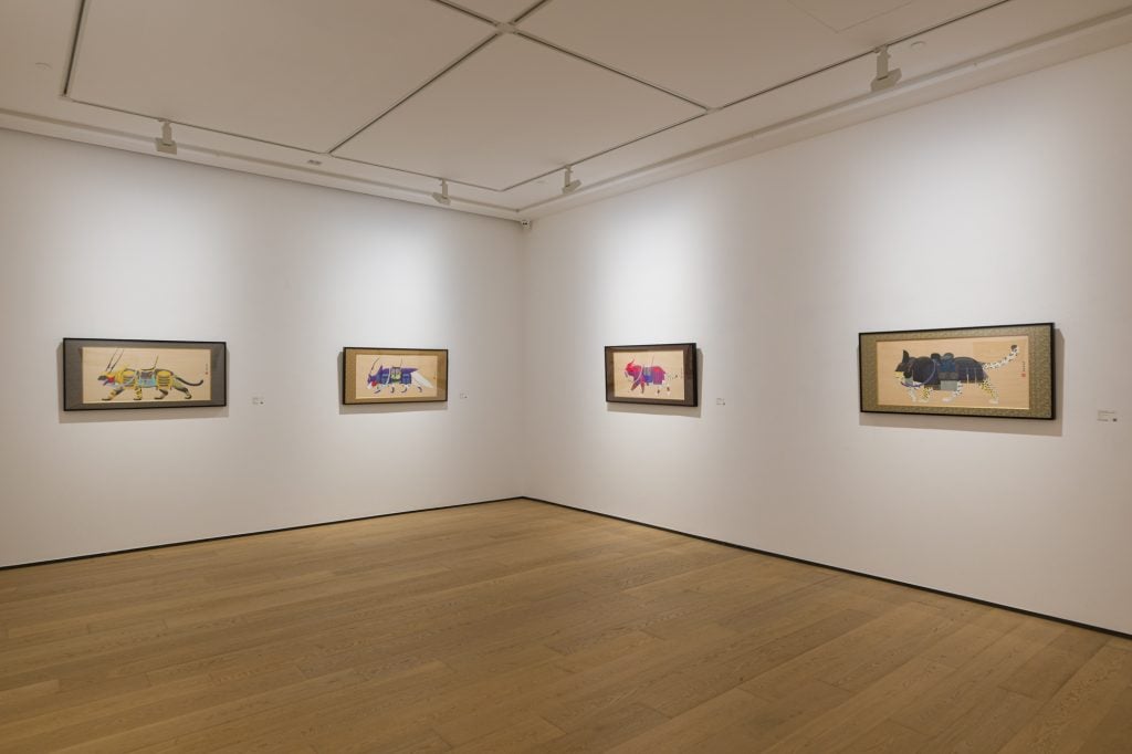 Installation view of "Tenmyouya Hisashi: Game of Thought" showing a white gallery space with four acrylic on board paintings of variously armored mythical creatures.