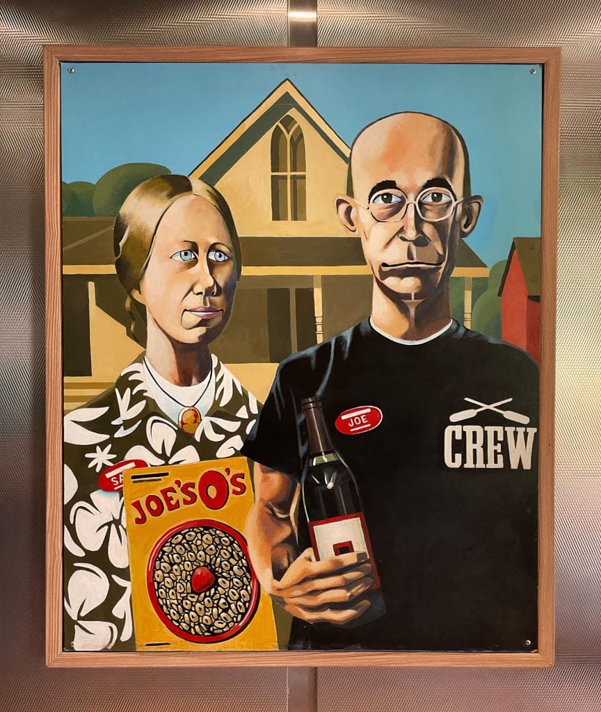 A parody of Grant Wood's American Gothic showing a man and woman dressed up as Trader Joe's employees.