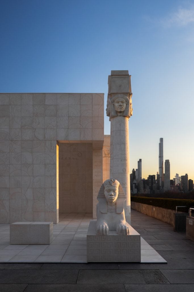 Lauren Halsey, the eastside of south central los angeles hieroglyph prototype architecture (I), 2022, installation view at the Roof Garden Commission. ©Lauren Halsey. Courtesy of the artist; David Kordansky Gallery, Los Angeles/New York. Photo by Hyla Skopitz, courtesy of the Metropolitan Museum of Art, New York.