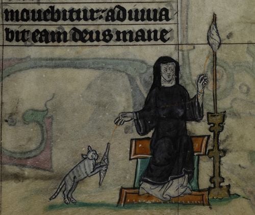 an illuminated manuscript of a nun playing with a cat