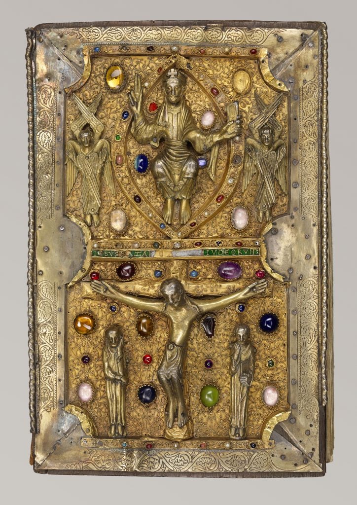 Gospels of Judith of Flanders. An ornately decorated gold bible with a crucifix and gemstones.