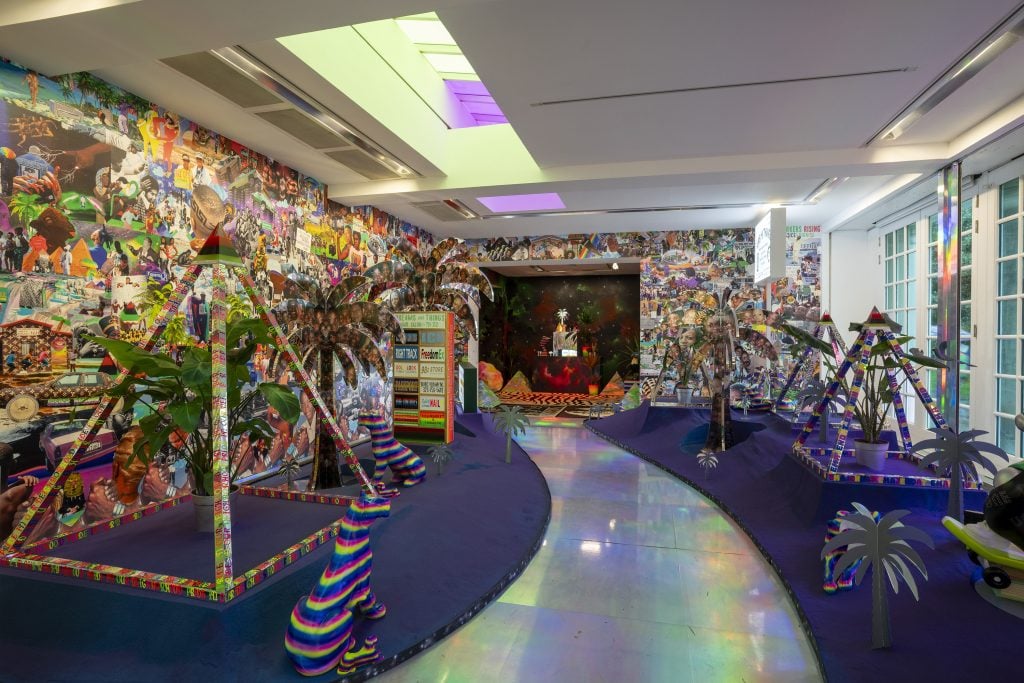 a silver path through violet carpet has colorful modern artwork including s pyramid sculpture 