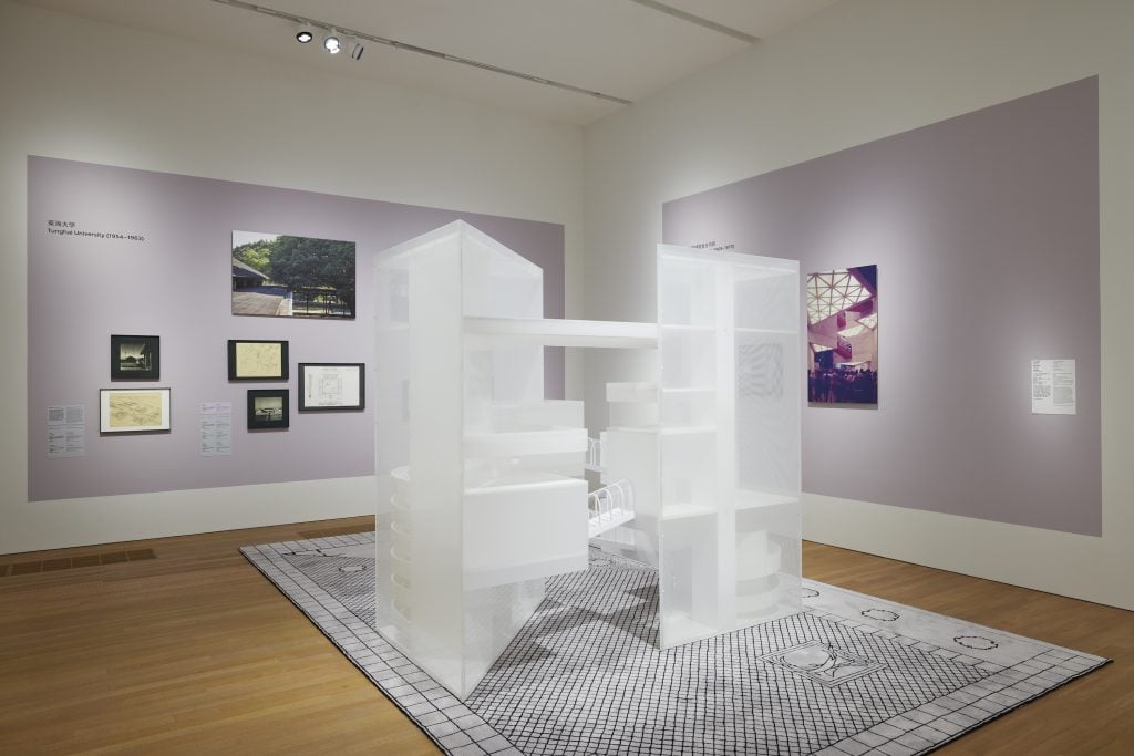 An architecture model in white on view at an exhibition.