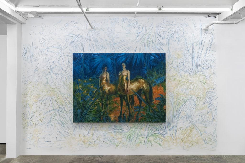 an installation view of a painting of two centaurs with the white wall drawn upon